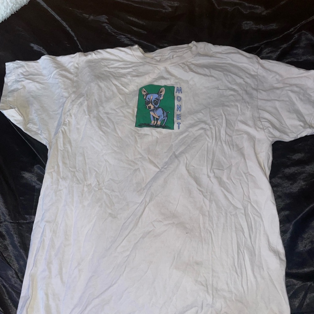 off white kind of color with a blue dog on the front